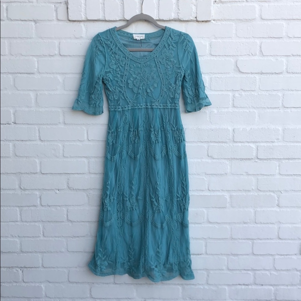 Midi length blue lace dress with 3/4 sleeves.
